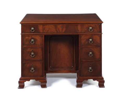 A George III mahogany kneehole bureau dressing table, attributed to Thomas Chippendale The rectangular moulded top above a fl