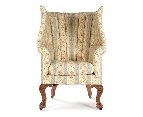 A rare large early 20th century oak carved barrel back wing chair by Howard & Son Ltd in George III style, the padded back, s