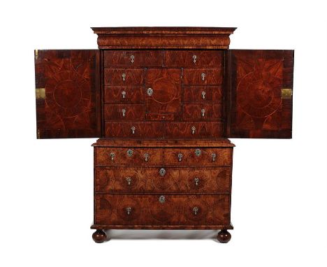 A William & Mary kingwood oyster veneered cabinet on chest attributed to Thomas PistorThe upper part with a moulded overhangi