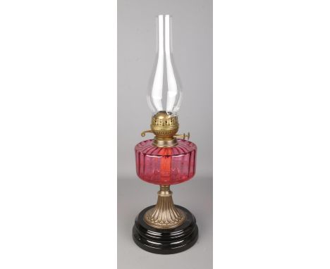 A Flash of Slough flamingo glass and brass oil lamp, on stepped circular base.  