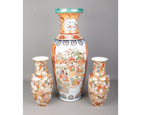 A collection of oriental ceramic vases to include large example featuring riverside village scene. Height of largest example 