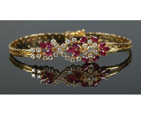 An 18ct gold ruby and diamond bracelet. Having London import marks, 1982. Length 18cm. 15.98g.  
