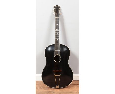 A vintage Milner acoustic guitar. Having black body, white trim and mother of pearl inlay to fret board. Label inside sound h
