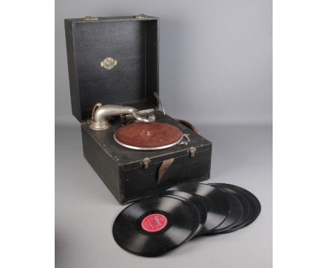 A Gilbert portable record player with a small selection of records.  