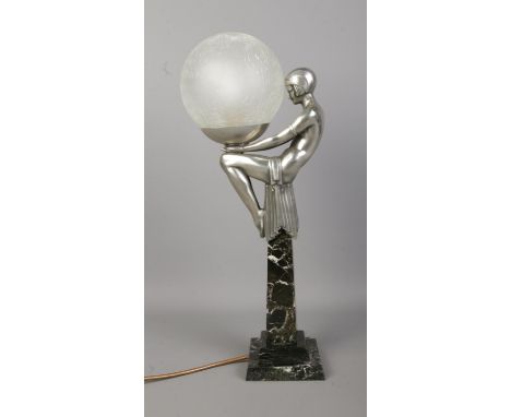 After Max Le Verrier (1891–1973), an Art Deco style table lamp formed as a female figure in a seated position holding a crack