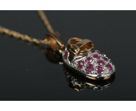 A 9ct gold ruby set shoe pendant on chain.2.95g  