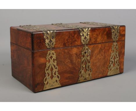 A Victorian burr walnut tea caddy with brass mounts.  Parts of corners missing/restored. Generally good condition.