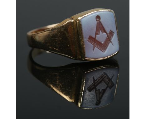 An 18ct gold Masonic ring, set with hardstone intaglio featuring square and compass. Size V 1/2. 7.4g.  
