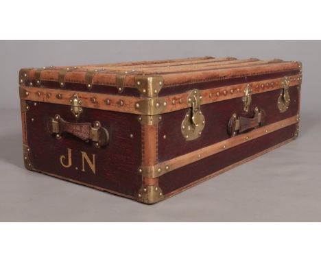 A vintage French wood and brass bound steamer trunk. The brass locks marked Surete.  