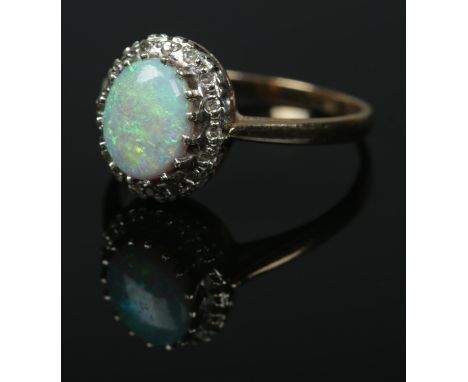 A 9ct gold ring set with large central opal cabochon stone within a moissanite surround. Size S, 3.10g.  