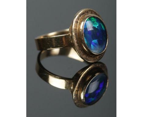 A 9ct gold opal doublet ring. Size O. 4.04g.  