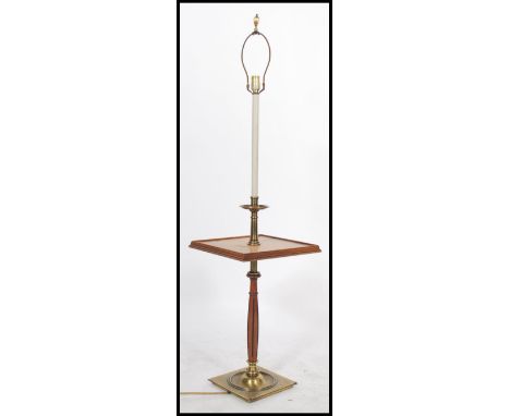 A 20th century brass and walnut standard lamp / occasional table raised on a brass and walnut base with a walnut tier of squa