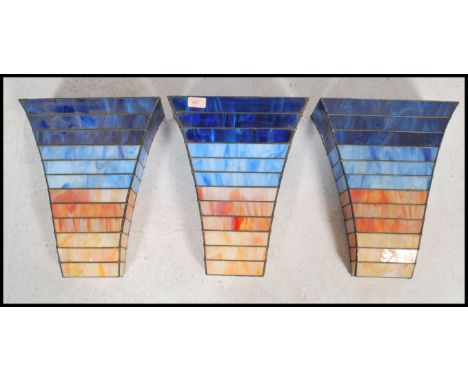 A set of three vintage 20th century Art Deco style stained glass panelled light fixture wall mounted pockets of stepped form 
