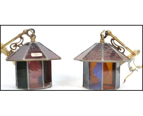 A pair of 20th century hanging porch lantern of octagonal form having leaded stained glass panels. Measures: 22cm high x 24cm