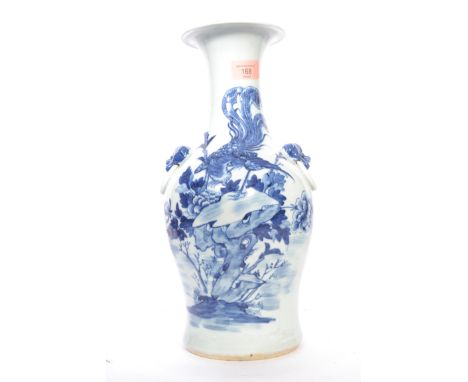 A late 19th / early 20th century blue and white Chinese ceramic vase decorated with phoenixes and foliage, with lion mask han