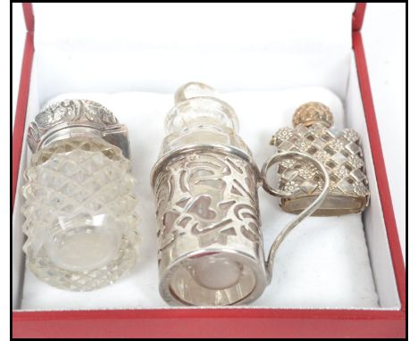 A group of three silver hallmarked perfume vials to include a miniature french example in the form of a hip flask (unmarked),