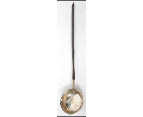 A Georgian silver whale bone toddy ladle, the ladle with incised initials to side of bowl, no hallmarks. Measures 29 cm long 