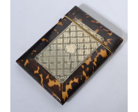 A 19th century tortoise shell card case having inset silver cartouche rectangular panel with plain armorial shield lozenge a 