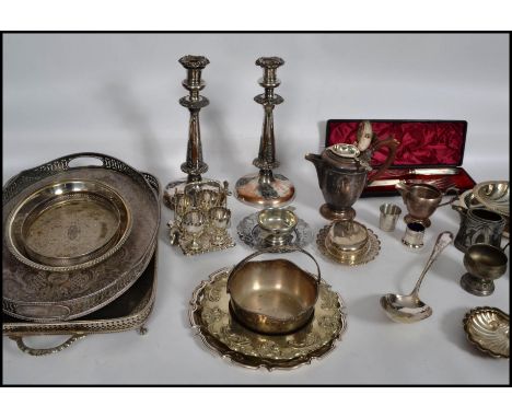 A large collection of silver plated wares to include a pair of large candlesticks, a 4 person egg coddler set with stand, par