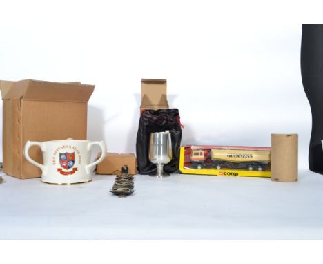 A collection of vintage collectable Guinness advertising items to include a Corgi 1169 boxed lorry, a boxed table top lighter