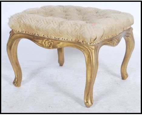 An early 20th century gilt plaster and wooden square footstool being raised on shaped legs with gilded plaster work having bu