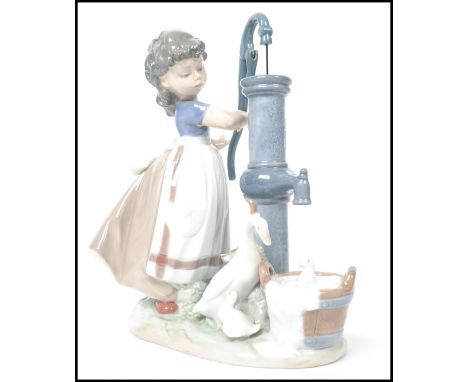 A Lladro ceramic figurine group entitled ' Summer on the Farm  ' depicting a girl with bow to hair at a water pump with duck 