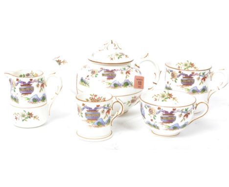 An early 20th century Royal Worcester tea service in the Pekin pattern consisting of teapot, tea cup , coffee can, mug and cr