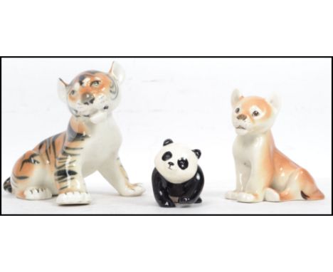 A vintage 20th century USSR / Russian Lomonosov ceramic tiger cub together with a Lomonosov Lion cub as well as a Beswick bab