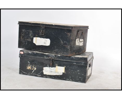 A pair of vintage 20th century tin storage trunks each having drop handles to side painted in an ebonised finish. Measures: 3