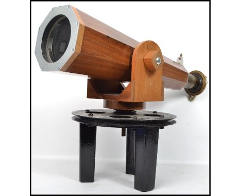 An unusual large wooden telescope of tapering form raised on a revolving large circular plinth, the large scope with fish eye