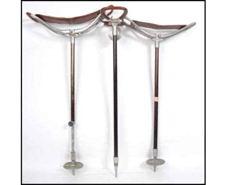 A group of three vintage 20th century shooting sticks with folding seats. Measures:  82cm high x 12cm deep x 42cm wide. 