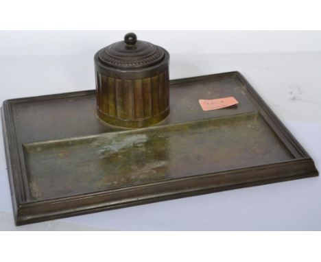 An early 20th century bronze inkwell desk tidy stand having a faceted inkwell with gadrooned lid with ball finial and glass r