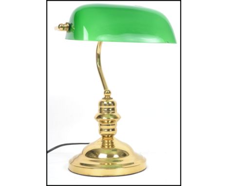 A 20th century contemporary green glass and brass bankers desk lamp having glass rectangular shade that adjusts. Measurements
