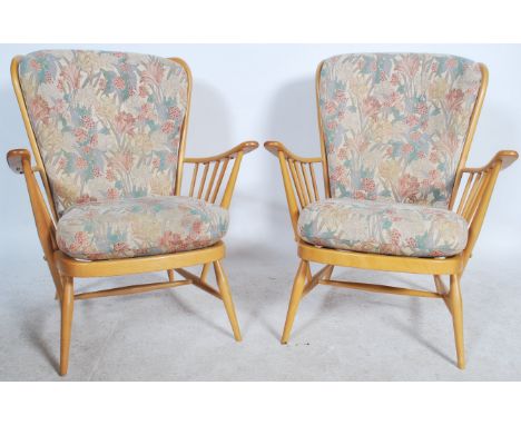 A good pair of 20th century retro Ercol Windsor armchairs. The turned legs united by stretchers having spindle back rests and