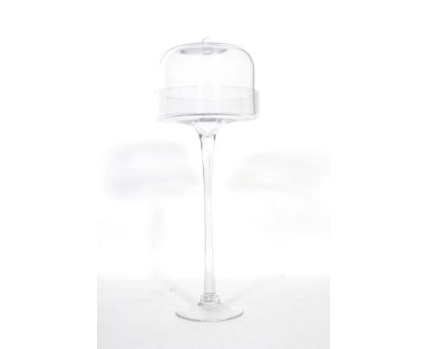 A vintage 20th century glass cake cloche stand of tall form, raised on a circular foot with tapering foot with lidded cloche 