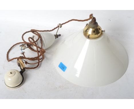 A vintage retro 20th century industrial rise and fall ceramic pendant light having a UFO type shade.