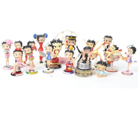 A group of four vintage Betty Boop figures with dogs to include cheer leader, Carnaby Street, Pilot, and Puppy Love along wit