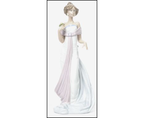 A Lladro ceramic figurine of a lady holding a flower posy entitled ' Summer Infatuation ' , number 6366 impressed to base. Me