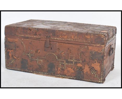 An early 19th century Georgian leather covered wooden trunk with brass studded decoration with label to interior for William 