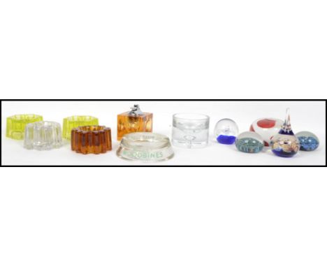 A collection of glass paperweights from the 20th century together with vintage glass piano castors, Pyrex rolling pin, Wills 