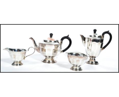 A four piece matching silver plated mid 20th century tea service to include teapot, water pot, sugar bowl and creamer, stampe