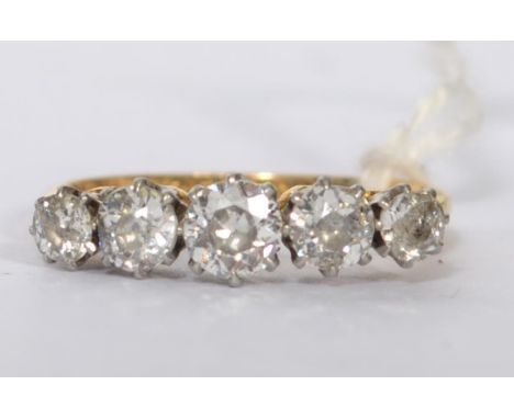 An 18ct gold and platinum, diamond 5 stone ladies ring. 5 claw mounted diamonds on a vintage setting, approx 75pnts. Total we