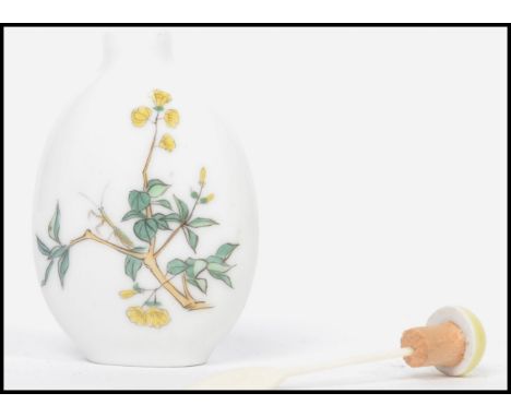 A 19th century Oriental ceramic scent perfume bottle having a white ground with painted floral sprays and flowering branches,