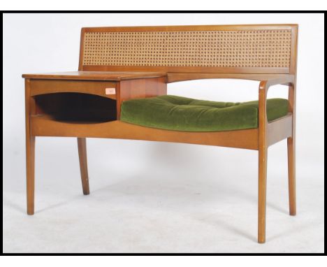 A retro 1970's teak wood telephone table / seat by Mr Chippy, rattan weave style back, button back seat pad with drawer above