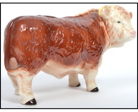 A vintage 20th century large Melba Ware ceramic figurine of a Hereford Bull being stamped to the base. Measures 15 cm high, 2