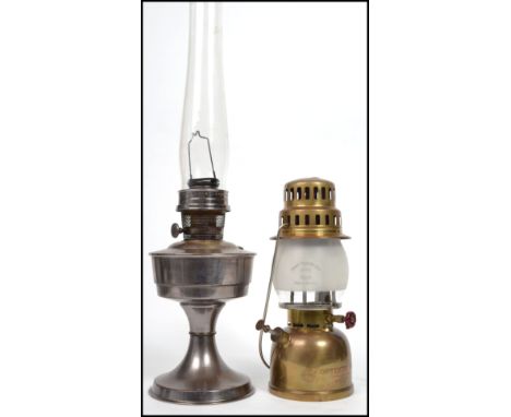 A vintage polished steel - metal oil lamp from the 20th century being marked for Optimas 930 with flue together with another 