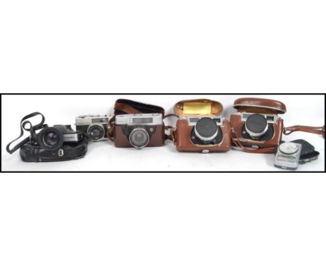 A collection of 5 vintage 20th century Japanese SLR camera's to include Mamiya, Yashika, Konica, Minolta etc along with cases