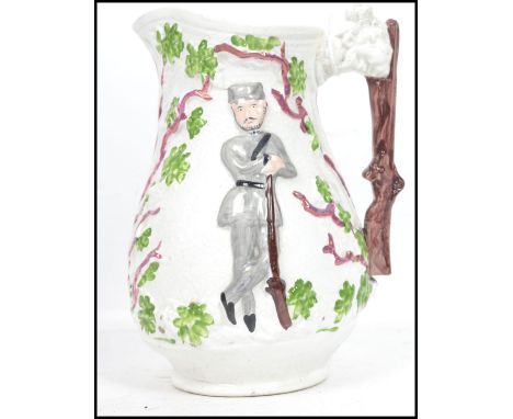 A 19th century Staffordshire Crimean war jug with trunk and lion mask handles and soldiers and trees to the jug itself . Fein