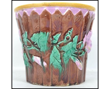 A 19th century Majolica ceramic jardiniere having a lilac ground moulded in relief with fences and flower. Measurements: 19 c