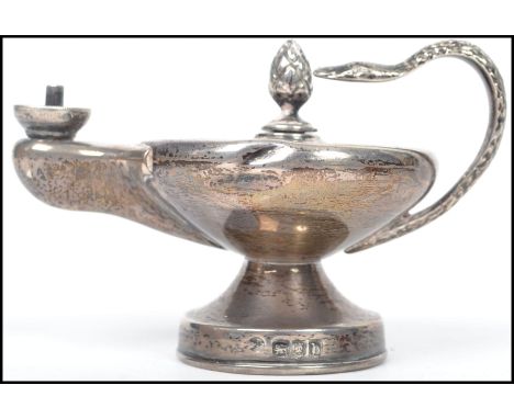 A silver ornate hallmarked Genie's Aladdin lamp oil burner with serpent head handle, bearing marks for London, date letter b,